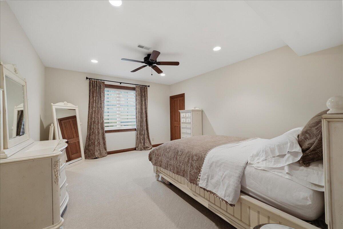 770 Quinlan Court Crown Point, IN 46307 - Photo 42 of 57 a bedroom with a large bed and a flat tv screen on dresser