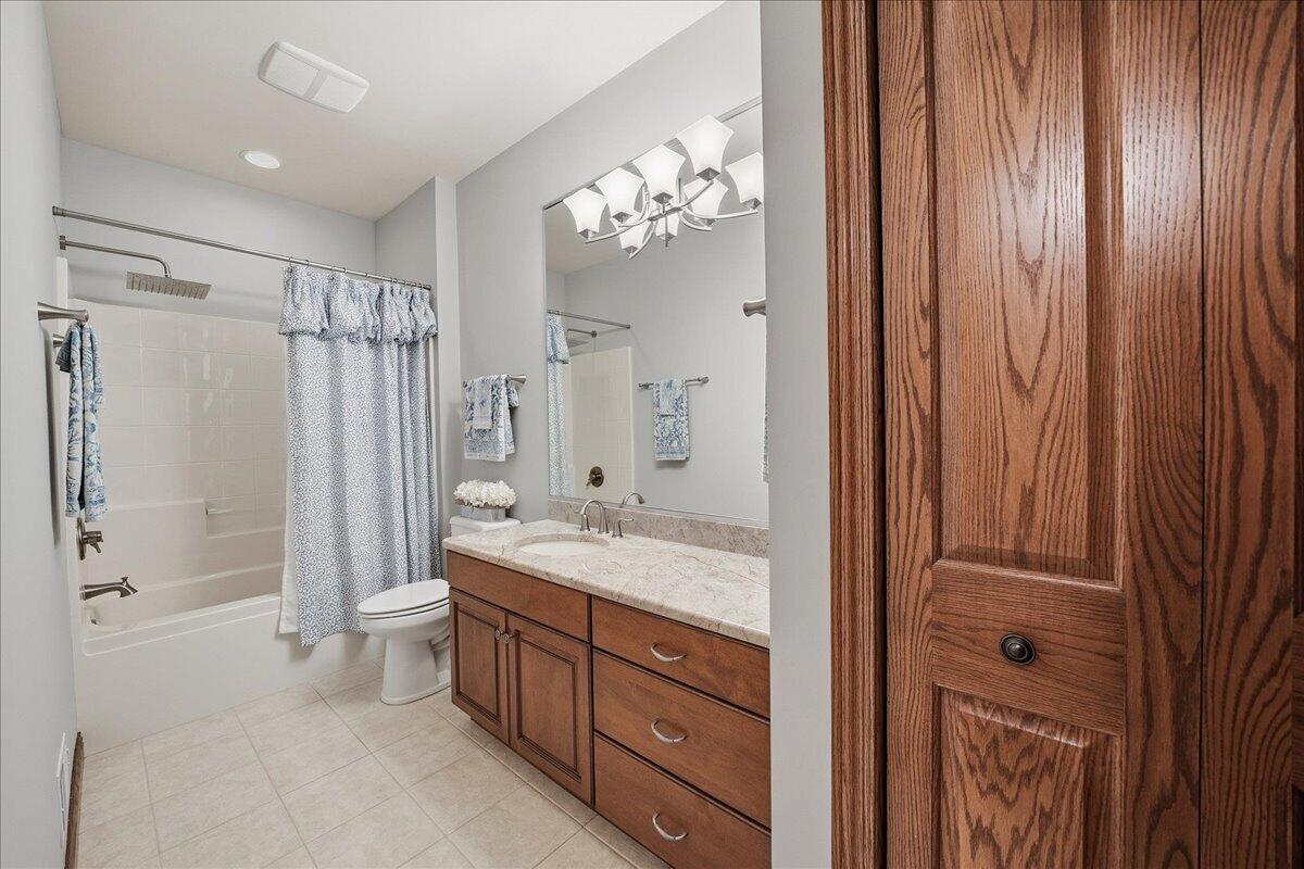 770 Quinlan Court Crown Point, IN 46307 - Photo 44 of 57 a spacious bathroom with a double vanity sink a large mirror a shower and a bathtub