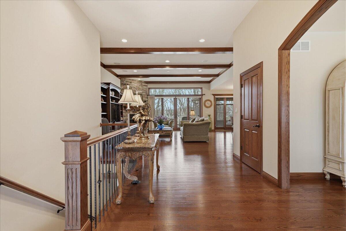 770 Quinlan Court Crown Point, IN 46307 - Photo 5 of 57 a view of a hallway with wooden floor fireplace and living room