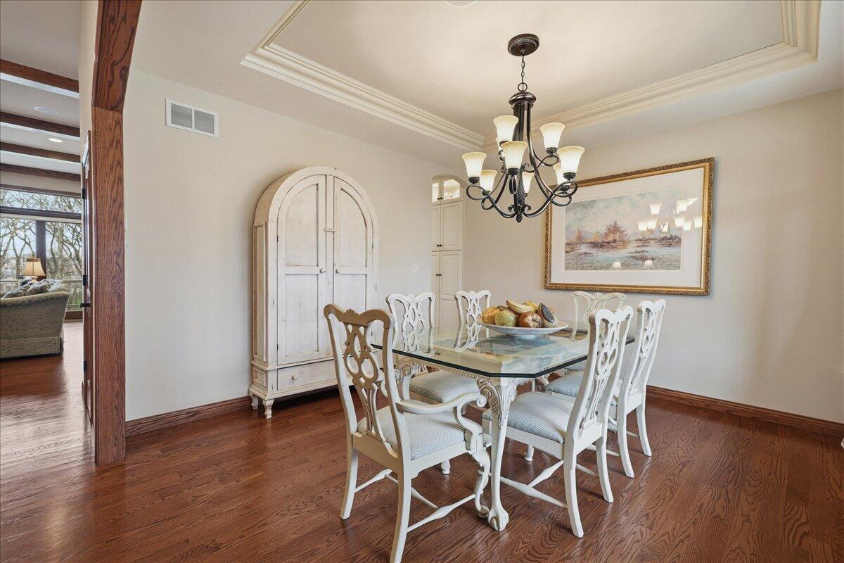 770 Quinlan Court Crown Point, IN 46307 - Photo 6 of 57 a view of a dining room with furniture wooden floor and chandelier
