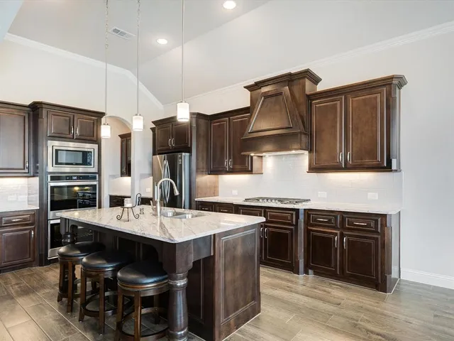 a large kitchen with a table and chairs