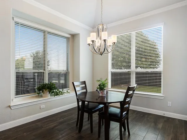 a kitchen with a table chairs and a fireplace