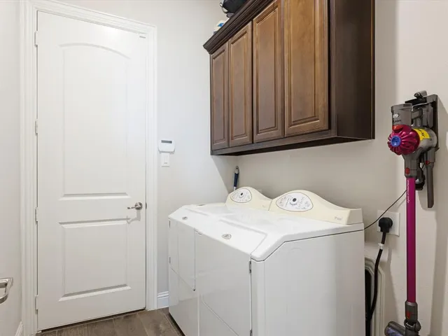 a bathroom with a bathtub and a double vanity sink