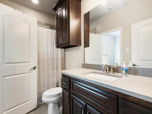 a view of a house with backyard and porch