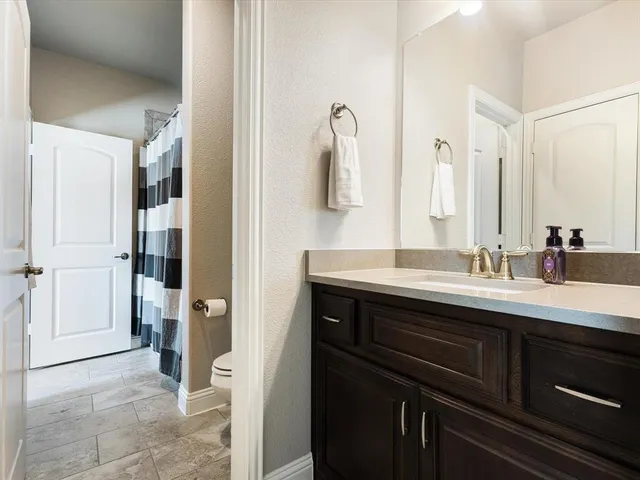 a spacious bedroom with a bed and a window