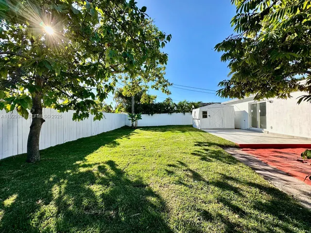 a view of yard with swimming pool and seating area