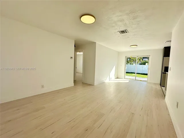 a kitchen with stainless steel appliances a stove a refrigerator and a sink