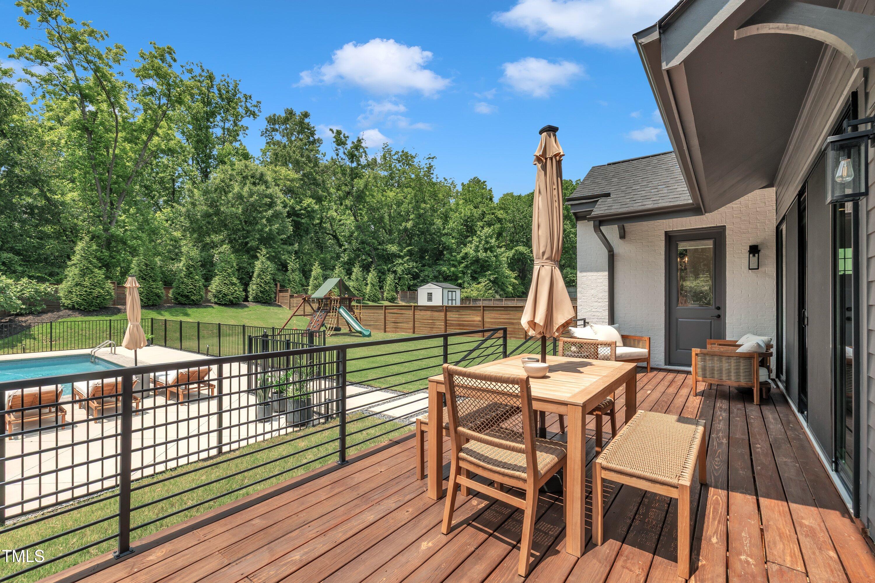 800 Wilcox Street Raleigh, NC 27607 - Photo 42 of 43 a view of a patio with a table chairs and a floor to ceiling window