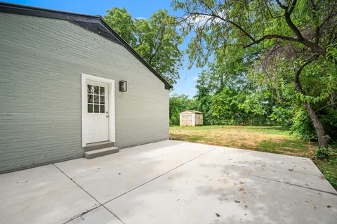 a view of backyard with large trees