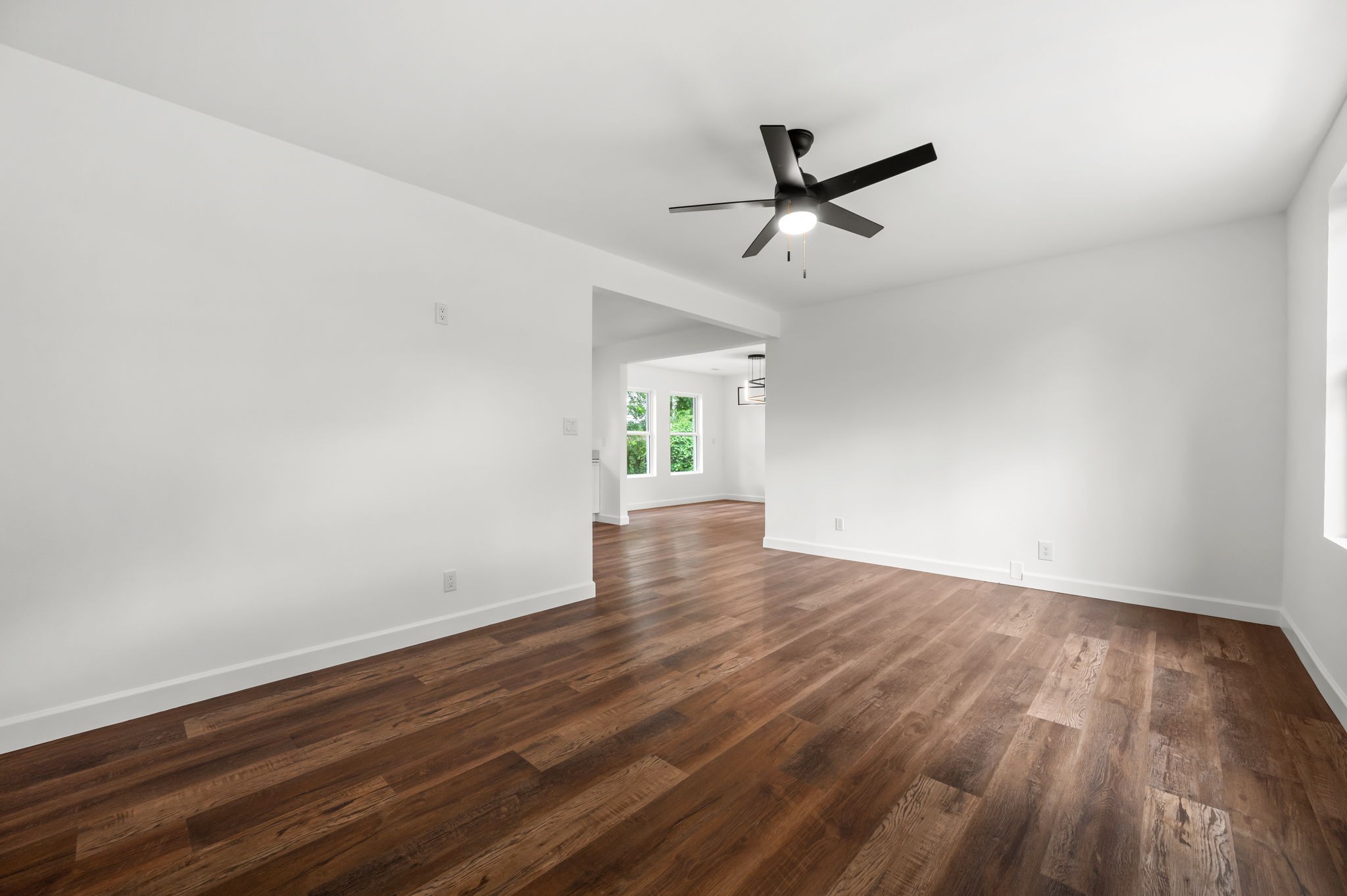 706 Mars Street Murfreesboro, TN 37130 - Photo 3 of 17 an empty room with wooden floor and windows