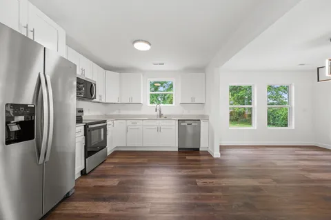 a kitchen with a white cabinets and stainless steel appliances