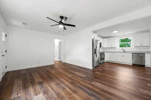 a view of a kitchen with a sink and a stove top oven