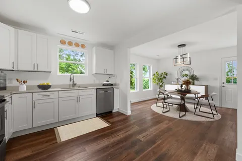 a kitchen with a sink cabinets and window