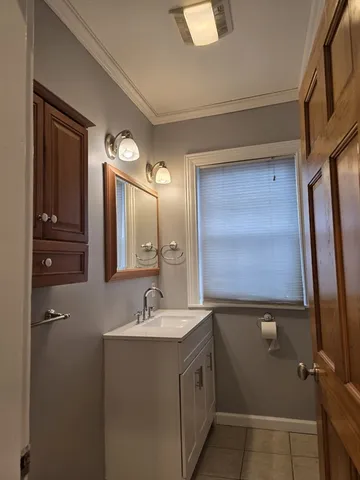 a bathroom with a sink mirror and vanity