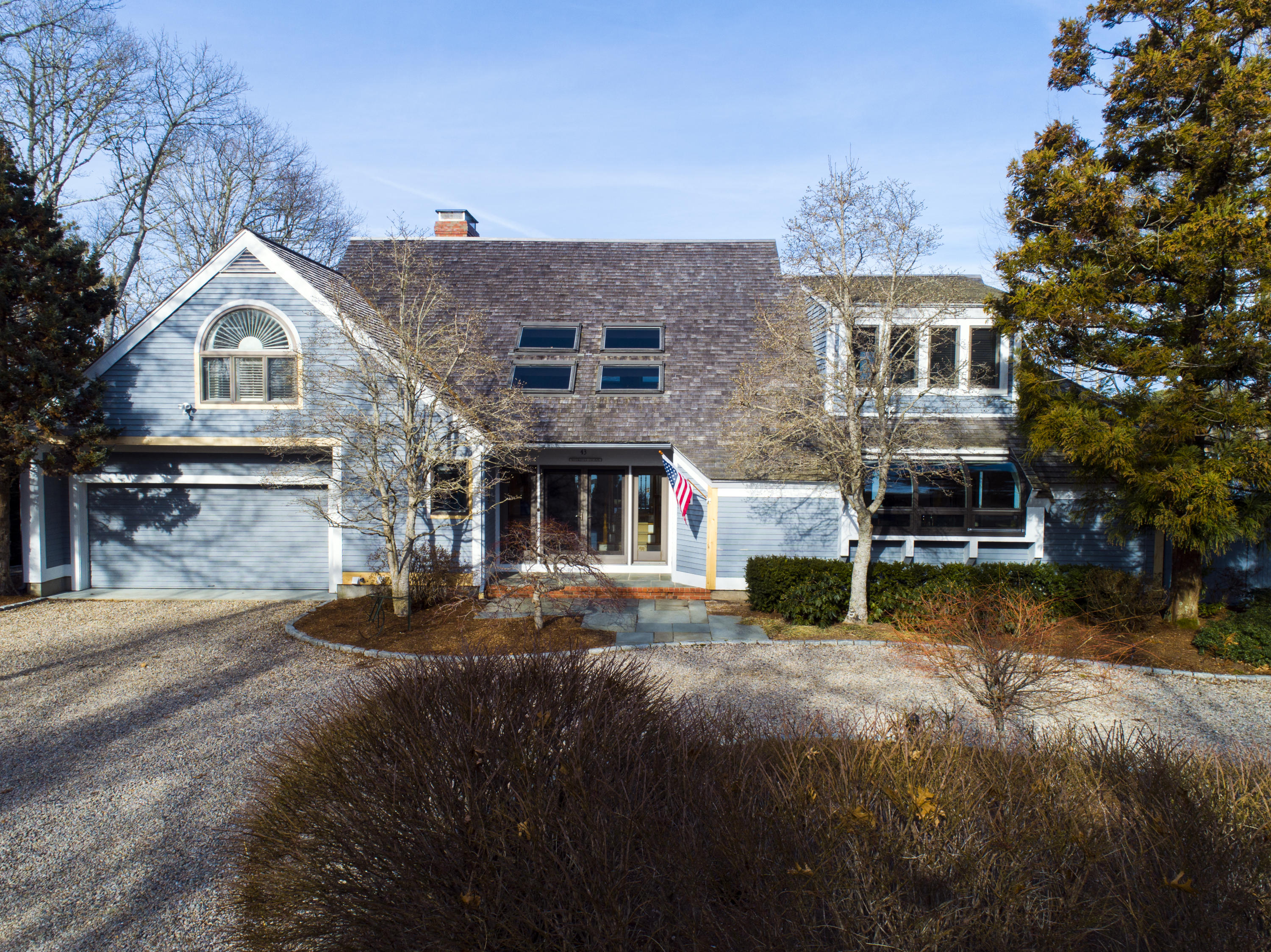 43 Tide Run Mashpee, MA 02649 - Photo 1 of 31 a front view of a house with a yard and garage