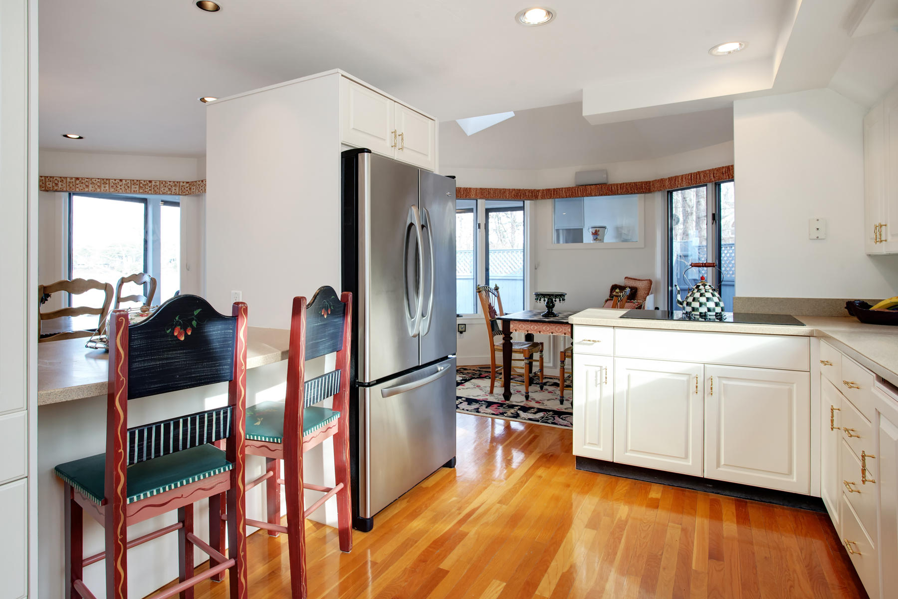 43 Tide Run Mashpee, MA 02649 - Photo 12 of 31 a kitchen with stainless steel appliances kitchen island granite countertop a refrigerator a stove and white cabinets with wooden floor