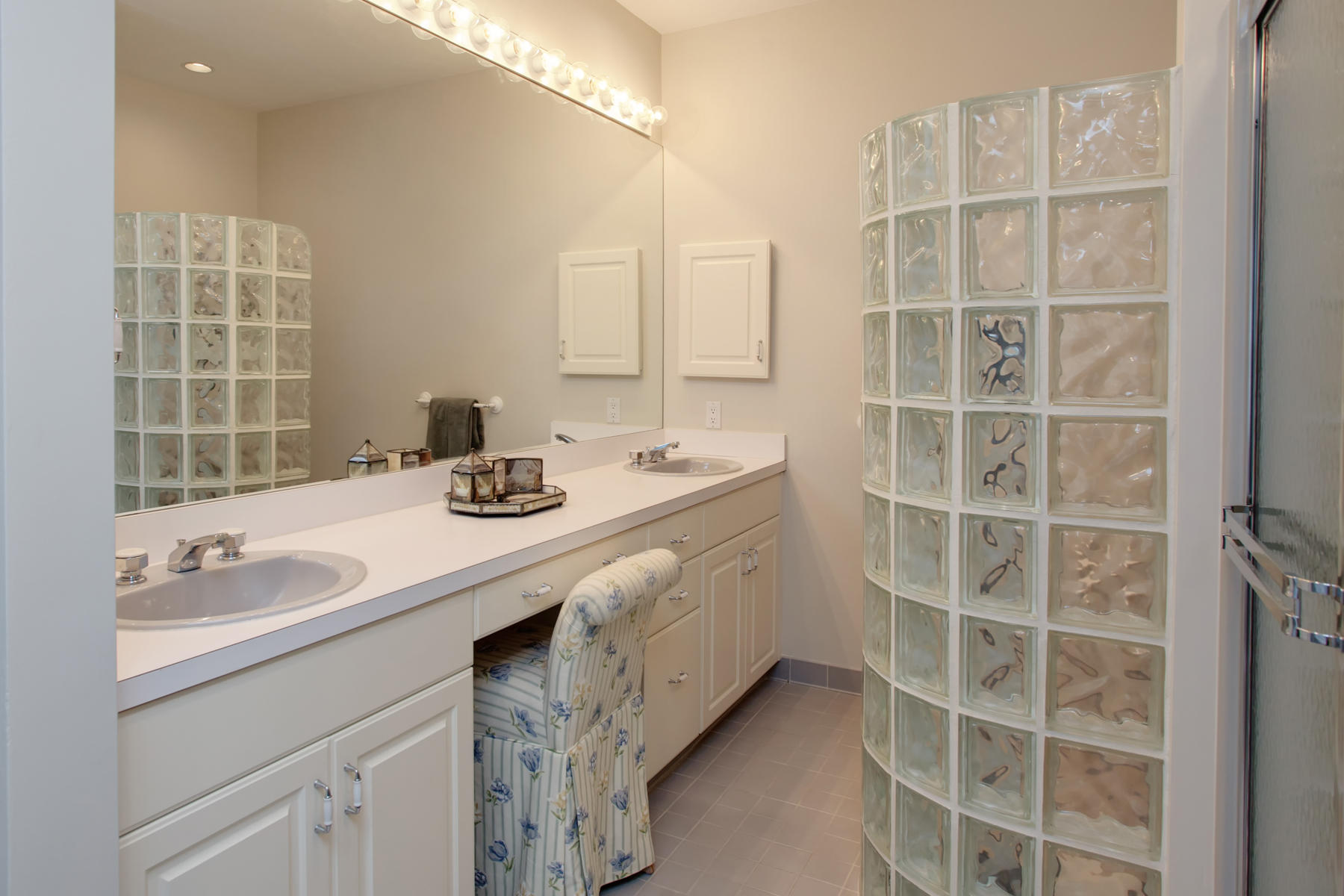 43 Tide Run Mashpee, MA 02649 - Photo 19 of 31 a bathroom with a double vanity sink a mirror and a shower