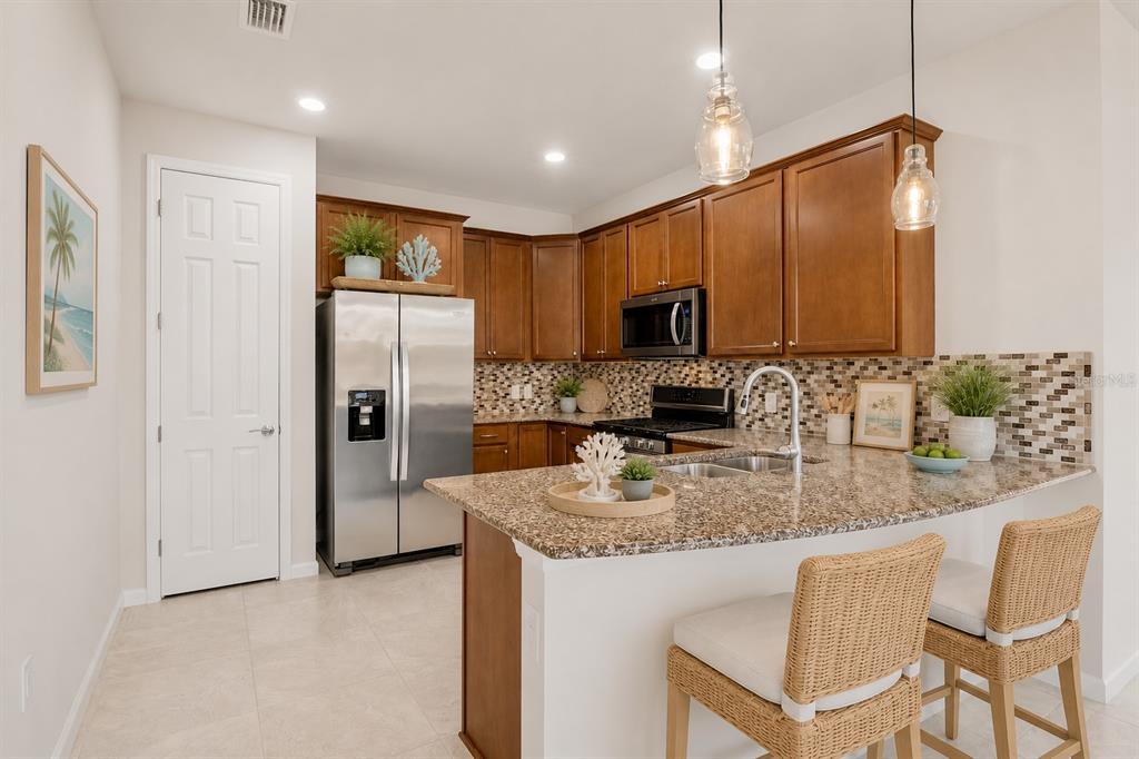 12276 Marsh Pointe Road Sarasota, FL 34238 - Photo 15 of 48 a kitchen with refrigerator cabinets and a counter top space