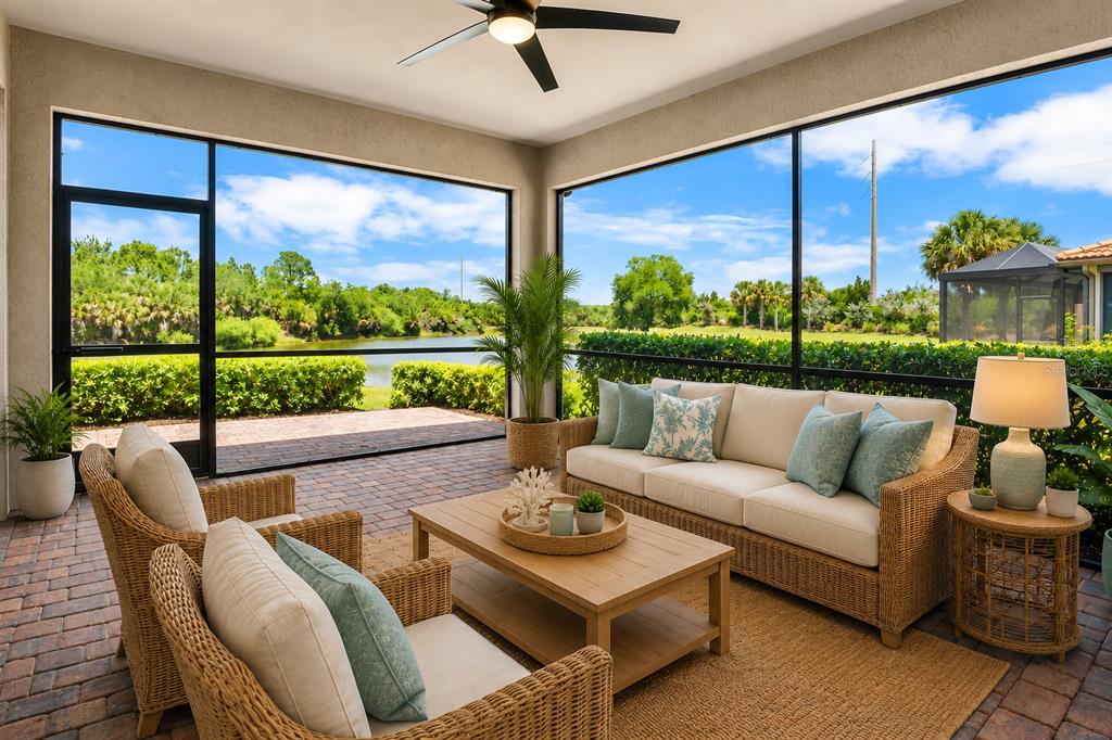12276 Marsh Pointe Road Sarasota, FL 34238 - Photo 18 of 48 a living room with patio furniture and a large window