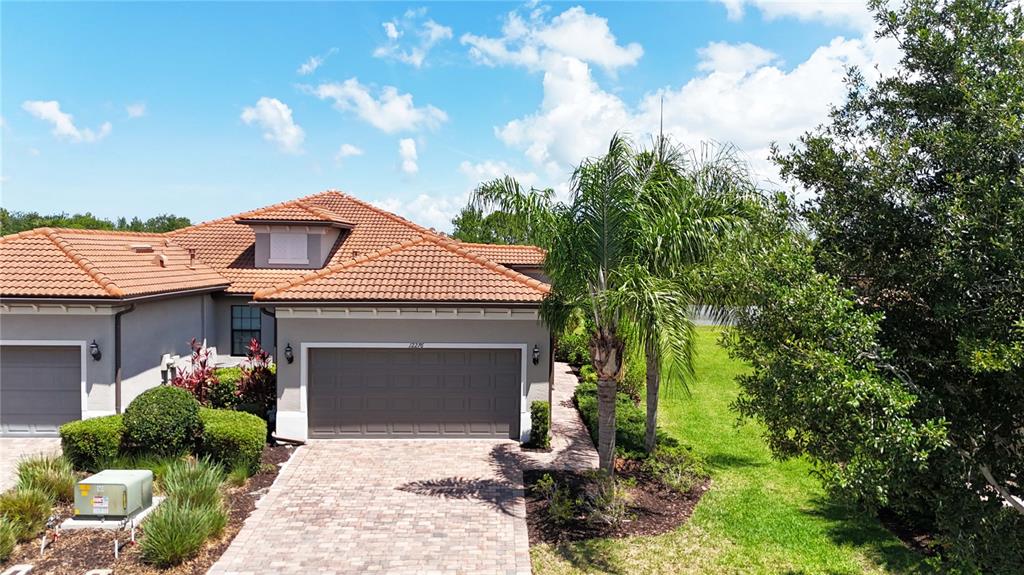 12276 Marsh Pointe Road Sarasota, FL 34238 - Photo 2 of 48 a front view of a house with a garden