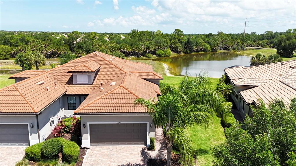 12276 Marsh Pointe Road Sarasota, FL 34238 - Photo 3 of 48 a aerial view of a house with pool lake and green space