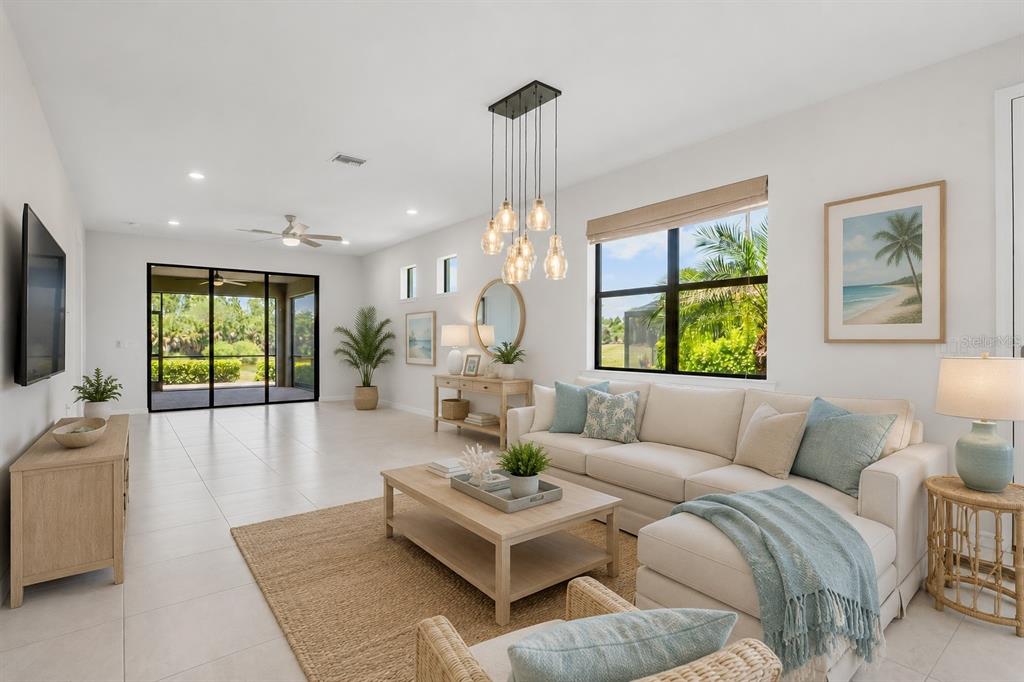 12276 Marsh Pointe Road Sarasota, FL 34238 - Photo 7 of 48 a living room with furniture chandelier and a large window