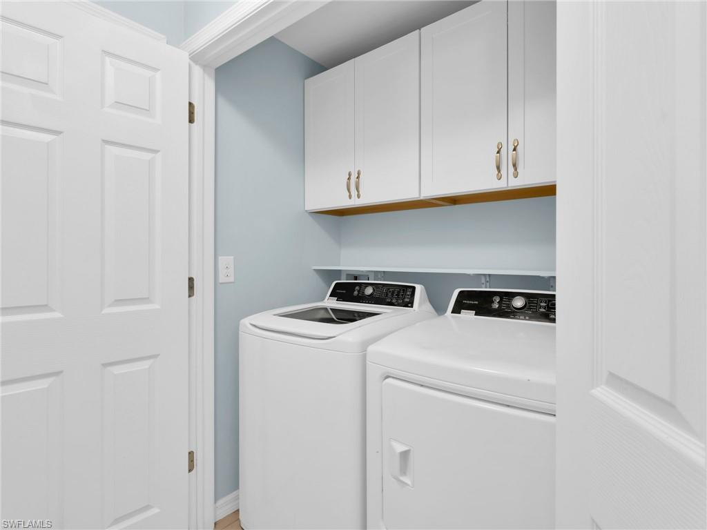 731 Hadley Place West Naples, FL 34104 - Photo 8 of 30 Laundry Room With GE Washer & Dryer and White Shaker Cabinetry