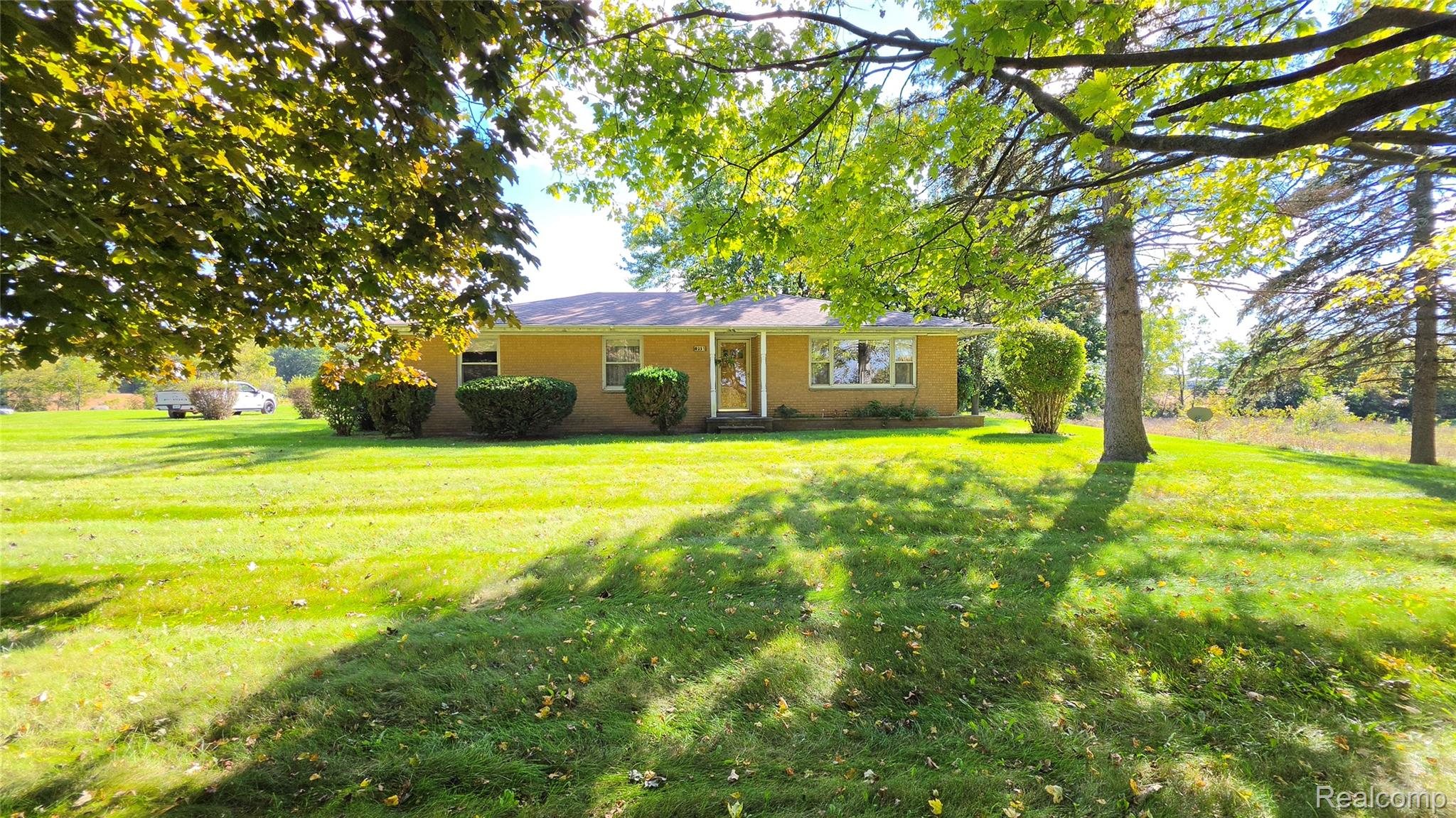 8251 West Ellsworth Road Ann Arbor, MI 48103 - Photo 1 of 57 Spacious green lawn surrounding the residence, featuring mature trees.