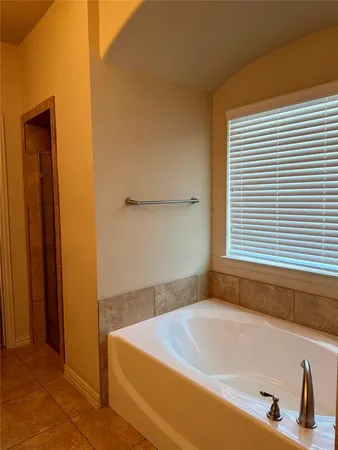 a bathroom with a tub and a window