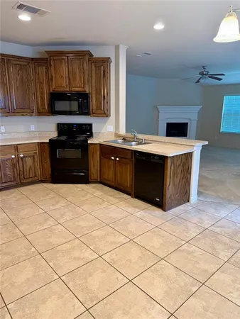 a kitchen with stainless steel appliances a stove a sink and a microwave