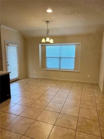 a view of a room with wooden floor and a window