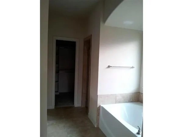 a bathroom with a tub and sink