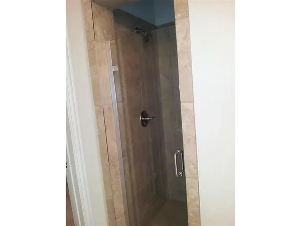 a bathroom with a shower and a mirror