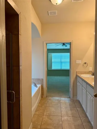 a bathroom with a tub and a sink