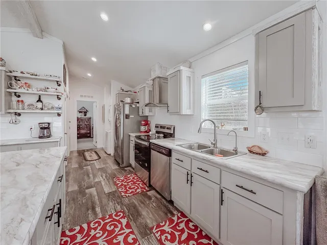 a view of a storage & utility room with a refrigerator
