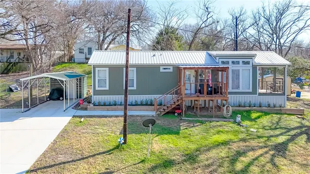 a view of a house with a yard patio and a slide