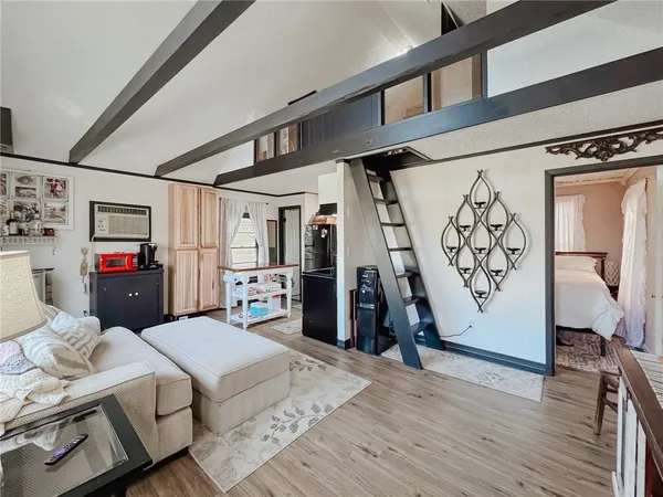 a bedroom with furniture and a flat screen tv