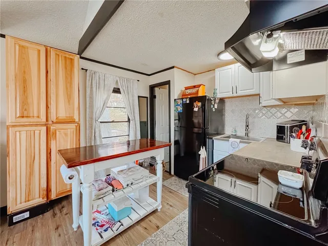 a view of a wooden chairs and table in the patio