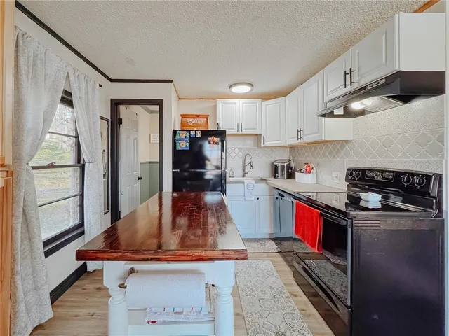 a view of a house with pool and chairs