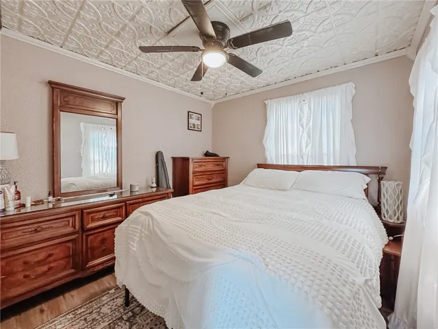 a living room with furniture a flat screen tv and a window