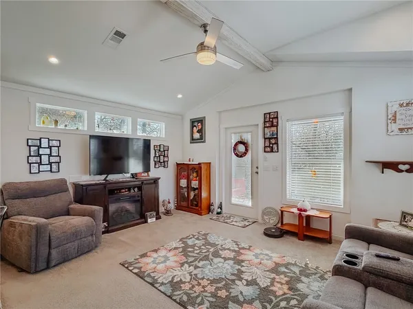 a living room with furniture and kitchen view