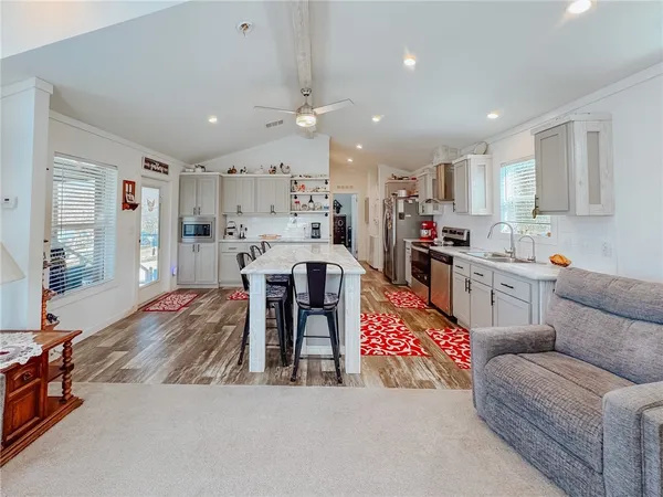 a kitchen with stainless steel appliances granite countertop a sink and cabinets