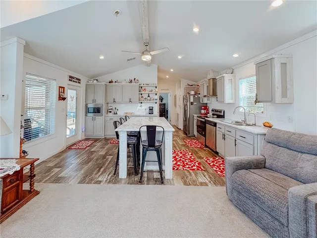 a kitchen with stainless steel appliances granite countertop a sink and cabinets
