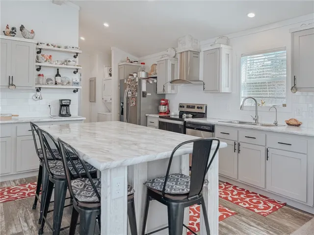 a bathroom with a granite countertop sink a toilet and shower