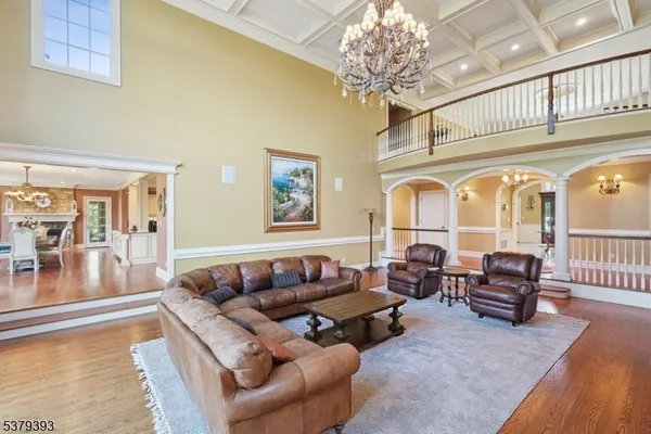 a living room with furniture and a chandelier