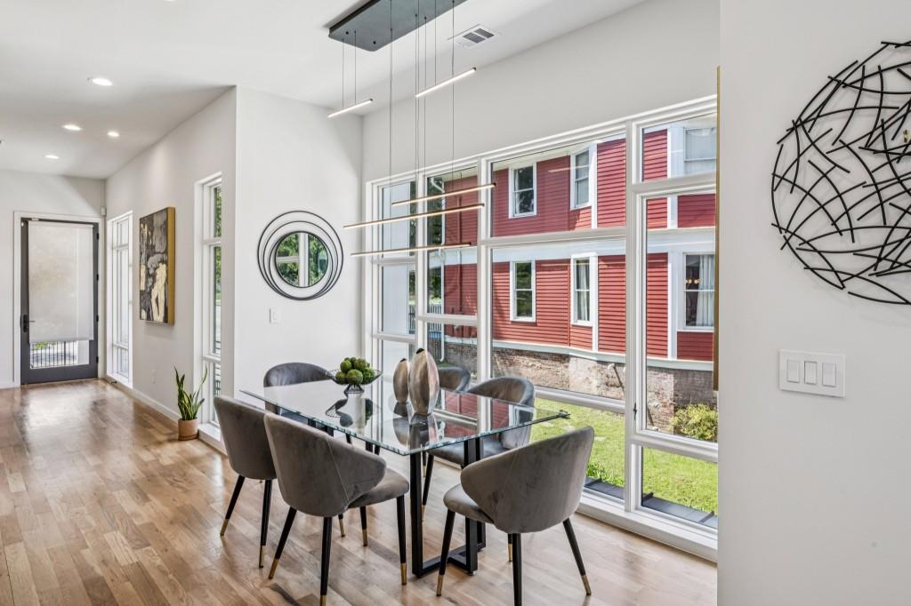 536 Highland Avenue Northeast, Unit A Atlanta, GA 30312 - Photo 17 of 51 a dining room with furniture and a clock