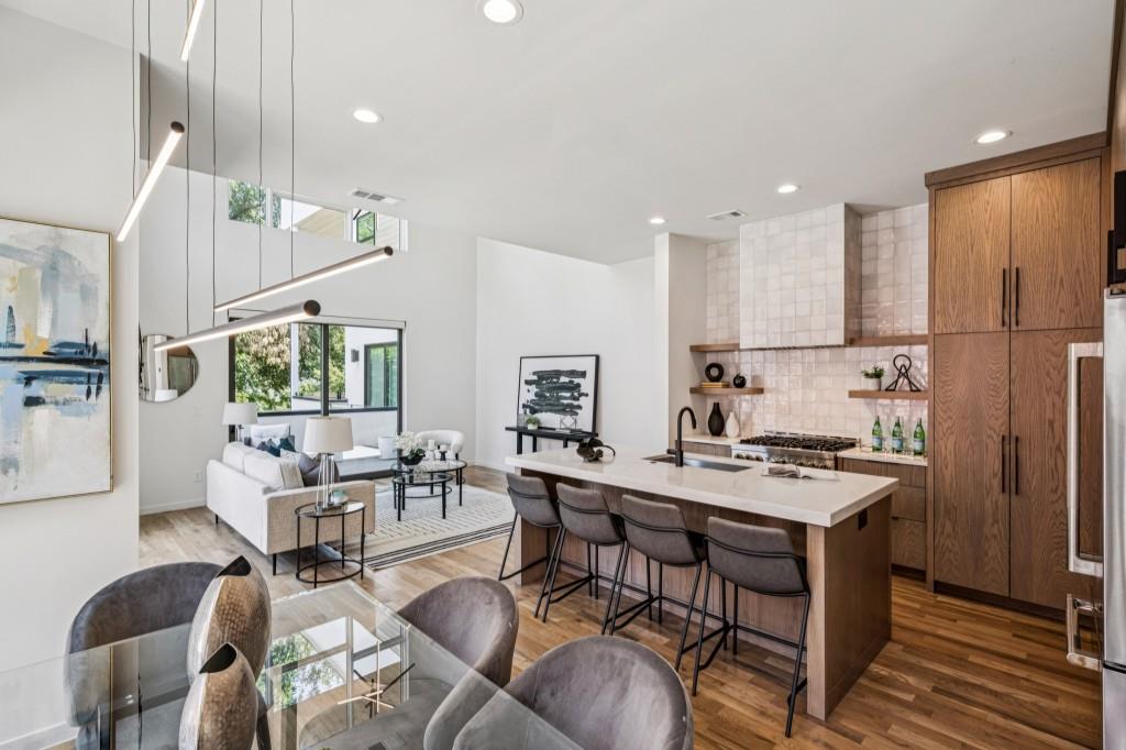 536 Highland Avenue Northeast, Unit A Atlanta, GA 30312 - Photo 2 of 51 a kitchen with stainless steel appliances a table and chairs in it