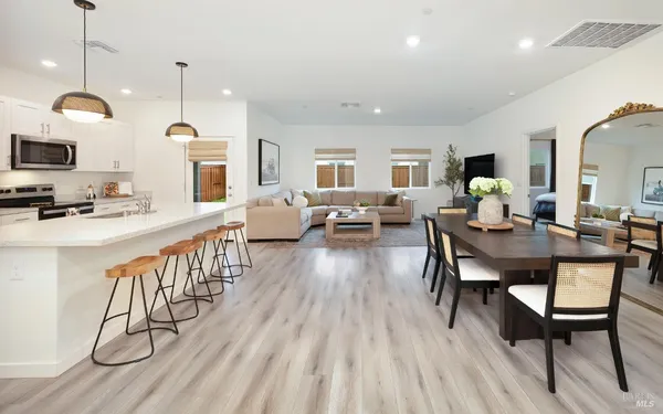 a view of a dining room with furniture window and wooden floor