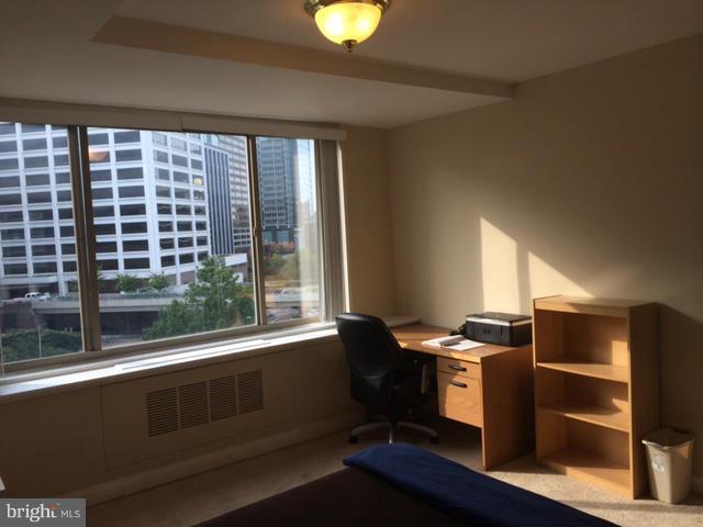 1121 Arlington Boulevard, Unit 842 Arlington, VA 22209 - Photo 11 of 30 a view of an empty room with wooden floor and windows