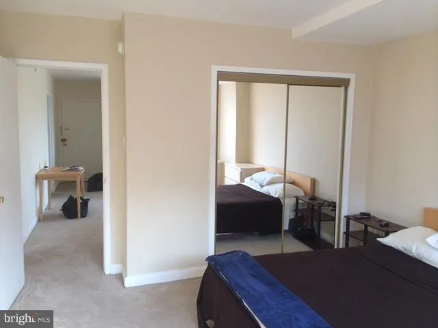 a bedroom with a bed and a mirror
